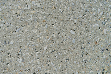 texture of the surface of concrete with small stones and a crack