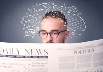Puzzled young businessman reading daily newspaper with speech bubbles above his head