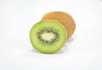 Half spiced kiwi with bright green kiwi isolated on white background
