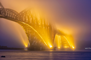 Evening view Forth Bridge in fog, railway bridge over Firth of Forth in Scotland