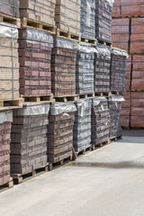 pallets with bricks in the building store. Racks with brick. Masonry, stonework.