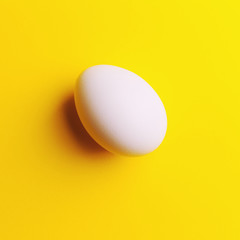 white egg on a yellow background