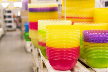 Plastic multi-colored bowls on the shelf in the store