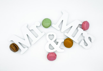 mr and mrs sign decorated with macarons isolated on white background