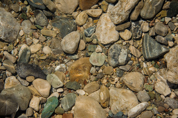 Background image of the brown and grey sea rocks