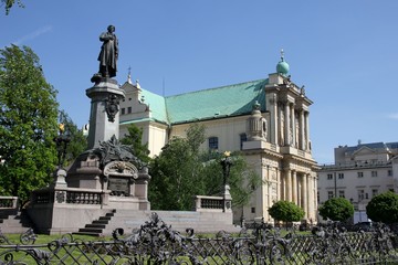 Monument of polish poet Adam Mickiewicz and Carmelite church at Krakowskie Przedmiescie street in Warsaw, Poland.