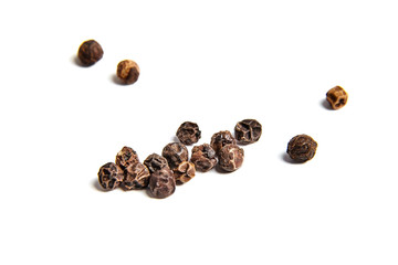 Black peppercorns on white background