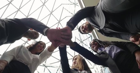 A group of business people from different ethnic backgrounds rejoices and celebrates their success in the financial and economic fields. 