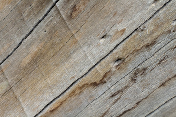 Wood board texture photo. Brown timber with weathered crack lines. Natural background for vintage design.