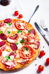 Hot pizza with Pepperoni Sausage on a white table