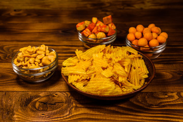 Different snacks for beer on wooden table