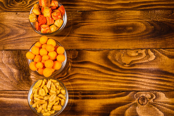 Different snacks for beer on wooden table. Top view
