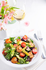 Fresh salad plate with shrimp, avocado, tomato and mixed greens