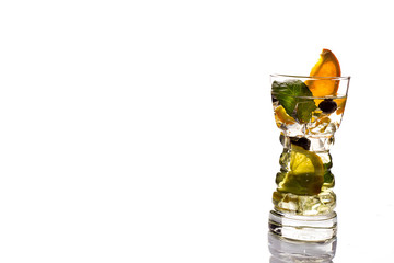 Low angle close up of ice cold modern gourmet craft cocktail of gin and tonic soda garnished by lemon slice