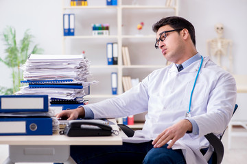 Busy doctor with too much work in hospital