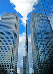 Reflection of a skyscraper on another skyscraper's windows nearby.