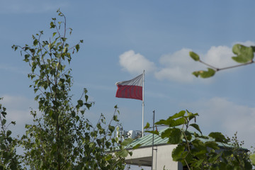 Poland white and red flag over the tower of the ski jumping hill in Wisla Malinka