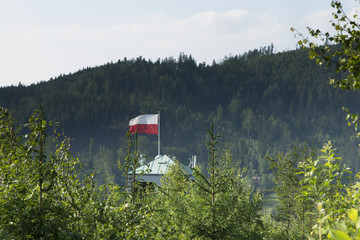 Poland white and red flag over the tower of the ski jumping hill in Wisla Malinka