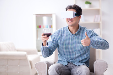 Young man drinking wine at home