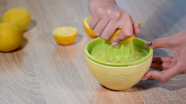 Squeezing fresh lemon juice into bowl.