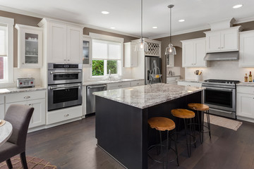 Beautiful Kitchen in New Luxury Home with Island, Oven, Range, Stainless Steel Appliances, and Refrigerator