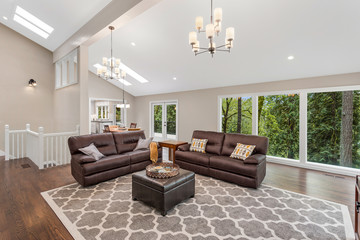 Beautiful living room with vaulted ceilings and hardwood floors in new luxury home