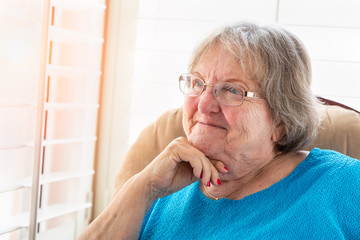 Content Senior Woman Gazing Out of Her Window