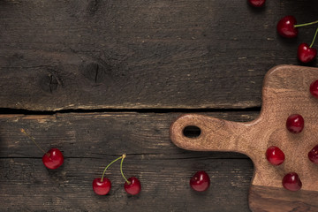 Wooden empty background with cherry berrie close up 