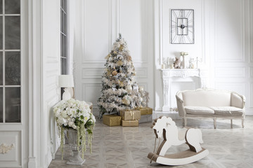 Toy wooden rocking horse in the New Year's interior. New Year's decorations. Decoration of the house. White wooden rocking horse.