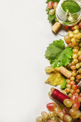 Dry white wine in glass and bottle, fresh gpare, frame, drink backround, top view