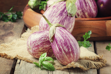 Fresh purple striped eggplants, rustic style, selective focus