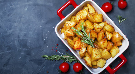 Baked potatoes with spices and rosemary, top view