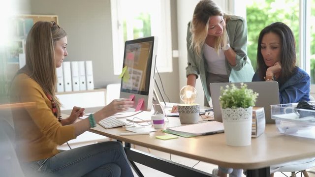 Start-up young women in office, co-working area