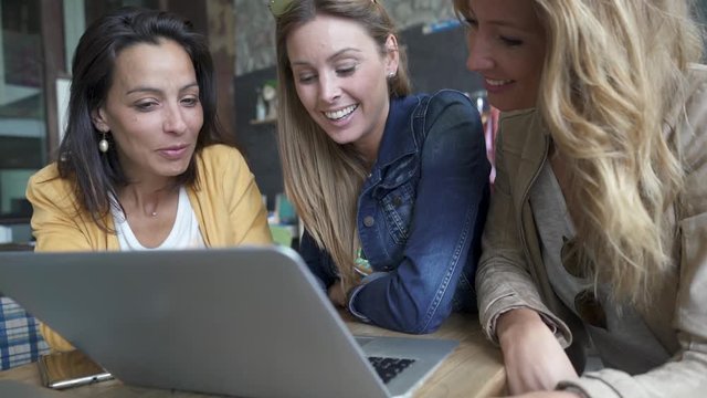 Friends connected on internet in coffeeshop