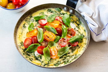 Basil frittata with halloumi, mixed tomatoes and basil leaves
