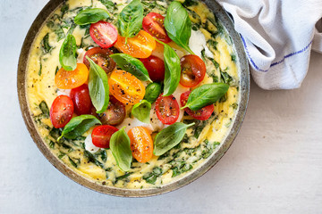 Basil frittata with halloumi, mixed tomatoes and basil leaves