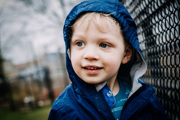 toddler boy playing in the rain