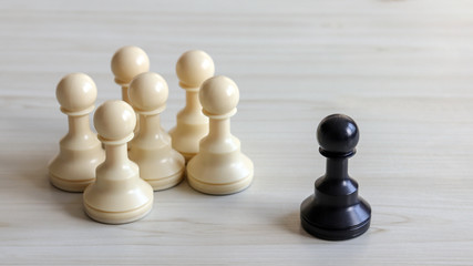 Six white chessman and a black chessman.