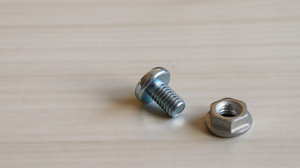 Bolt and nut on the table. Required because they are different from each other.