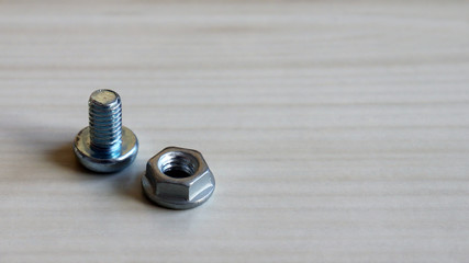 Bolt and nut on the table. Required because they are different from each other.