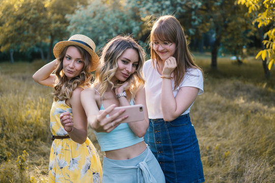 Group of girls friends making picnic outdoor. They make selfie photo from smartphone. bachelorette, party