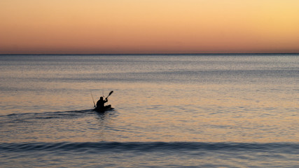 Fototapeta premium Paddling towards sunrise. Beautiful beach sunrise shot during coastal hike to Cape Kidnappers located in Hawke´s bay, North Island area of New Zealand