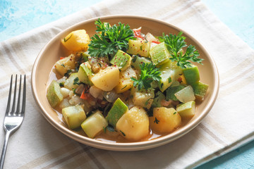 Braised zucchini with vegetables and sesame seeds. Rustic delicious cuisine.