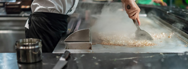 Ice cubes on hot stove. Way to clean and maintenance stainless steel stove after cooking.