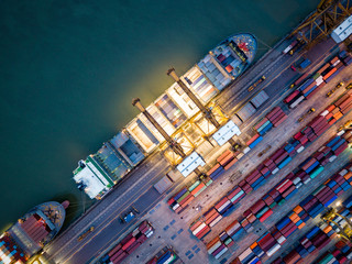 Top view of international port with Crane loading containers in import export business logistics at...
