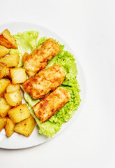 Fish and chips on a plate, white background, top view