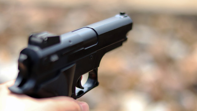 Close-up image of gun on the blur background.