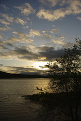 Tree and Land on the River with Setting Sun