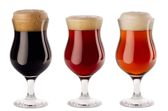 Beers collection poured in wineglasses with foam - lager, red ale, porter -  isolated on white background.