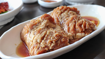 Two loaves of pork ribs in a white dish.